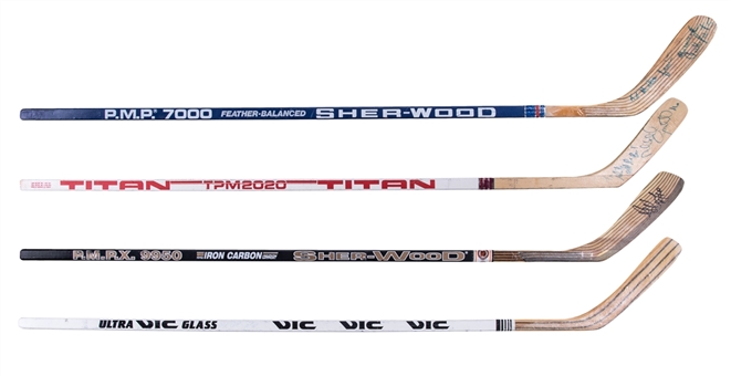 Lot of (4) Game Issued and Signed Hockey Sticks Including Ray Bourque, Bryan Trottier, Norm Rochefort and Michel Goulet (Beckett PreCert)